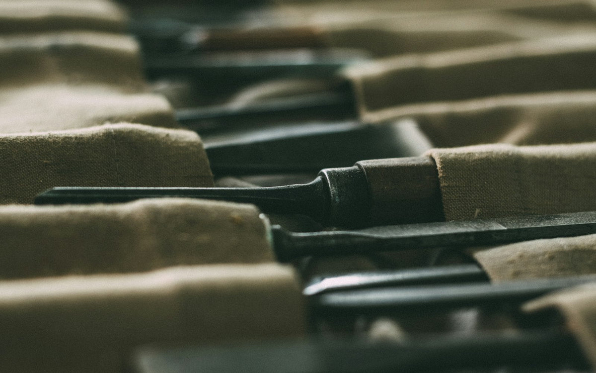 Row of screwdrivers with wooden handles in a workshop - EQUIPE Egypt