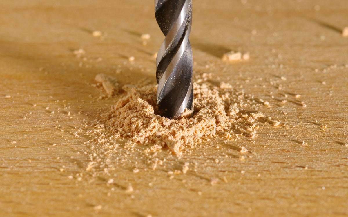 Power drill drilling a hole in a piece of wood - EQUIPE Egypt